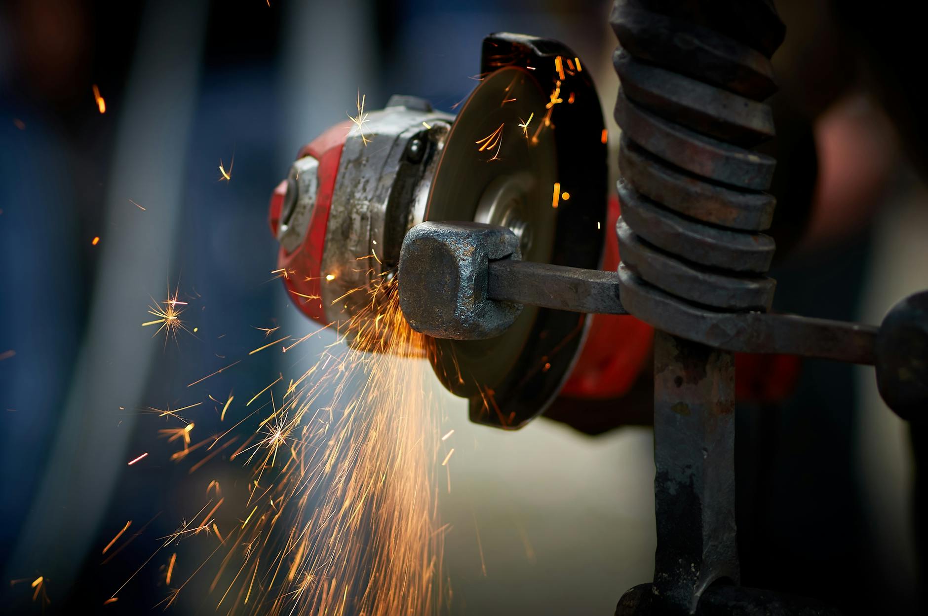 Dynamic close-up of an angle grinder in action, emitting bright sparks as it shapes metal.