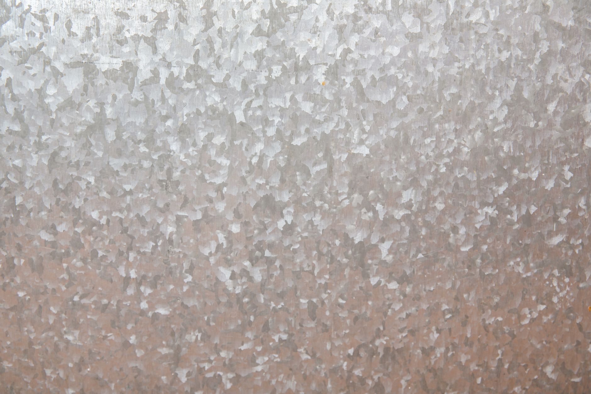 A detailed view of a rough, silver metal texture perfect for design backgrounds.